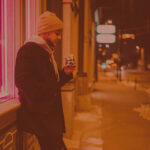 man eating a snack on the street to blow off some steam