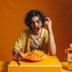 Young man emotional eating comfort food