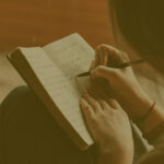 young woman writing a food diary with her own hand