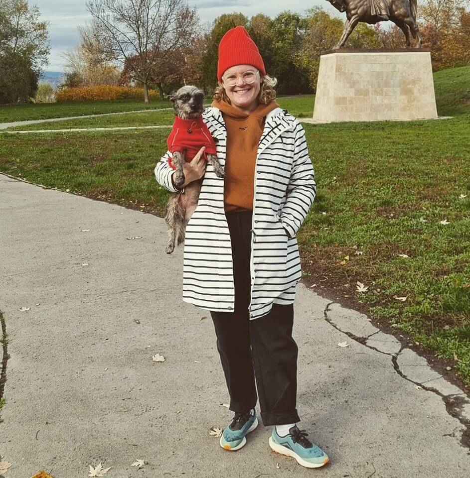 Susanna standing with her dog and happy with her weight loss success story